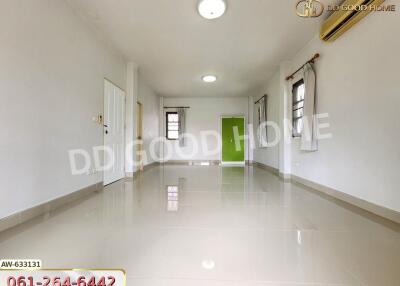 Spacious living area with tiled flooring, windows, and ceiling lights