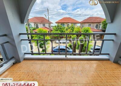 Balcony view of a residential area with houses and trees