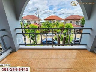 Balcony view of a residential area with houses and trees