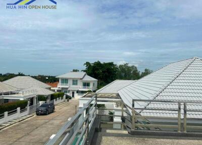 rooftop view of residential neighborhood with white houses and clear sky