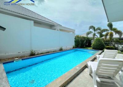 Outdoor area with swimming pool and lounge chairs