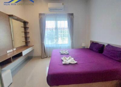 Modern bedroom with purple bedding