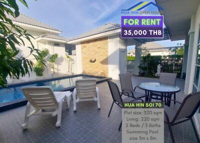 Outdoor area with pool, lounge chairs, and view of the building