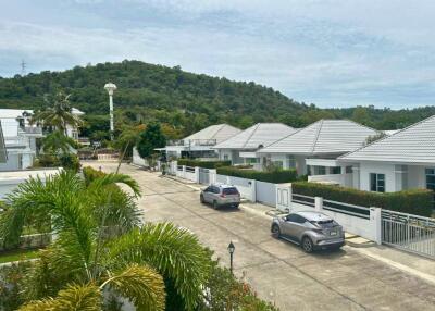 View of a residential neighborhood with houses and parked cars