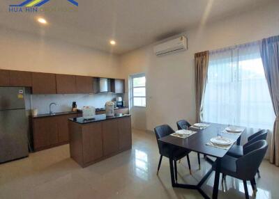 Modern kitchen and dining area with appliances