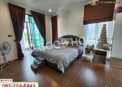 Spacious bedroom with large bed and balcony