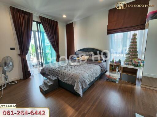 Spacious bedroom with large bed and balcony