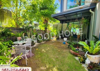 lush garden area with outdoor seating and various plants