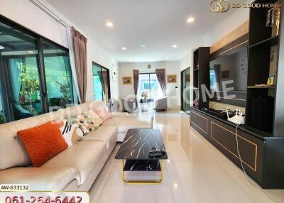 Spacious and modern living room with stylish decor and entertainment center.