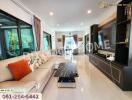 Spacious and modern living room with stylish decor and entertainment center.