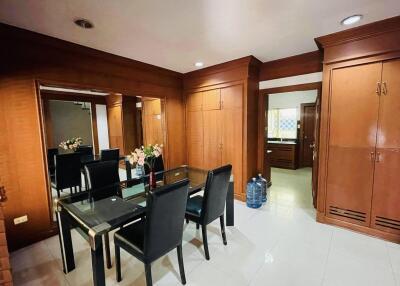 Dining area with wooden cabinets and glass table