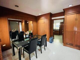 Dining area with wooden cabinets and glass table