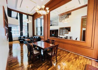 Elegant dining area with large wall mirror and wooden furniture