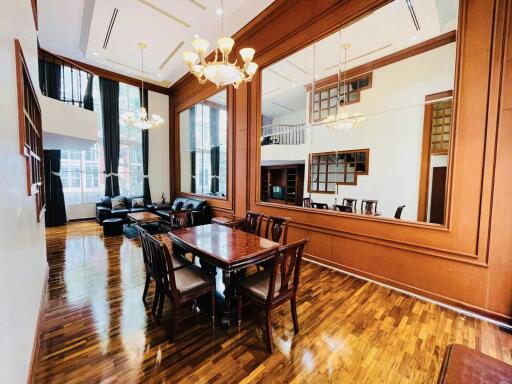 Elegant dining area with large wall mirror and wooden furniture