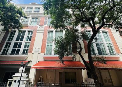 Exterior view of a multi-storey building with red awnings