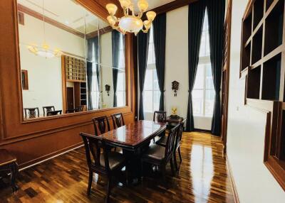 Spacious dining room with large mirror and elegant wood furnishings