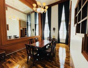 Spacious dining room with large mirror and elegant wood furnishings