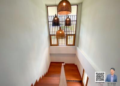 Modern staircase with wooden steps and pendant lights