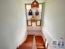 Modern staircase with wooden steps and pendant lights