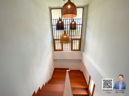 Modern staircase with wooden steps and pendant lights