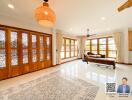 Spacious living room with large windows and wooden features