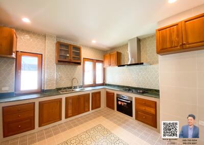 modern kitchen with wooden cabinets and tiled flooring