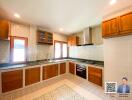 modern kitchen with wooden cabinets and tiled flooring