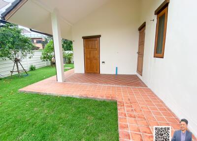 Outdoor view of a house entrance with a tiled patio