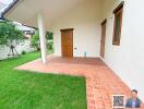 Outdoor view of a house entrance with a tiled patio