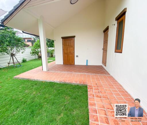 Outdoor view of a house entrance with a tiled patio