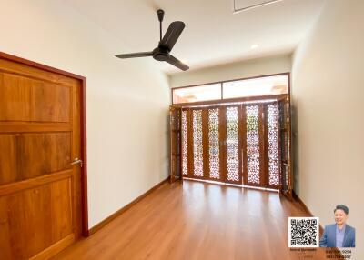 Spacious living area with wooden flooring and decorative sliding doors