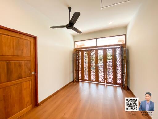 Spacious living area with wooden flooring and decorative sliding doors