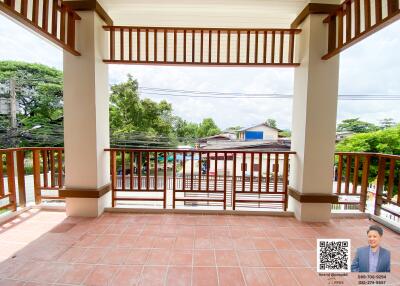 Spacious balcony with tiled flooring and wooden railing