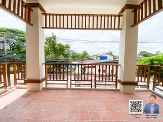 Spacious balcony with tiled flooring and wooden railing