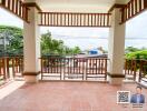 Spacious balcony with tiled flooring and wooden railing