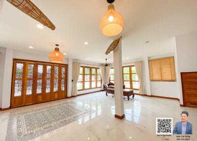 Spacious living room with large windows and natural light