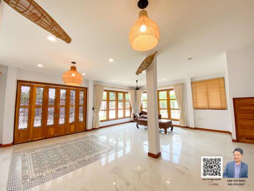 Spacious living room with large windows and natural light