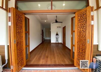 Open living room with wooden floors and ornate sliding doors