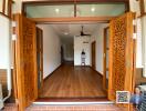 Open living room with wooden floors and ornate sliding doors