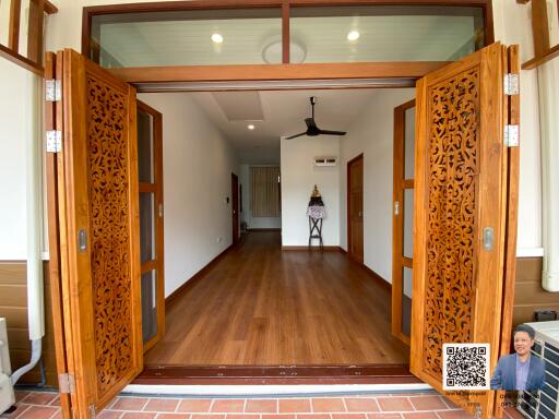 Open living room with wooden floors and ornate sliding doors