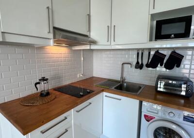 Modern kitchen with wooden countertop and appliances