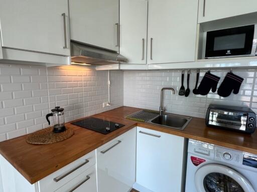 Modern kitchen with wooden countertop and appliances