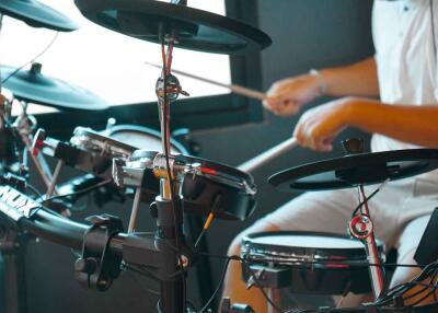 Person playing electronic drum set