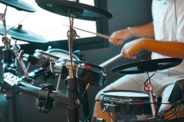 Person playing electronic drum set