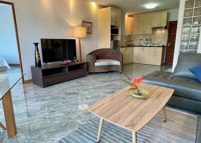 Spacious modern living room with a kitchen in the background