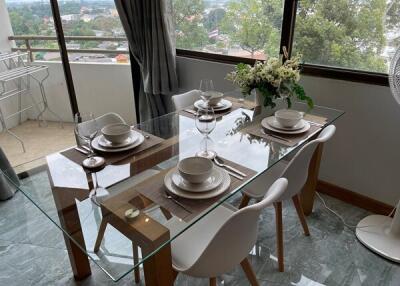 Dining room with glass table and white chairs