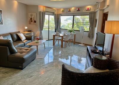 Modern living room with a large window and balcony