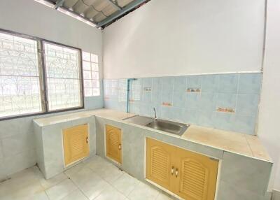 Bright kitchen with tiled backsplash and window