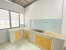 Bright kitchen with tiled backsplash and window