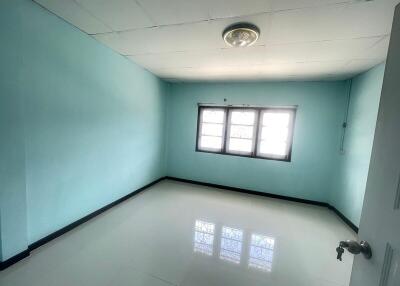 Empty bedroom with blue walls and a window